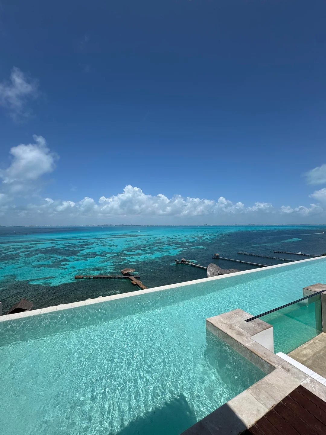 Rooftop infinity pool overlooking the reef and piers at Impression Isla Mujeres