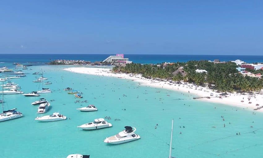 Aerial view of Playa Norte on Isla Mujeres, with boats moored in calm turquoise water