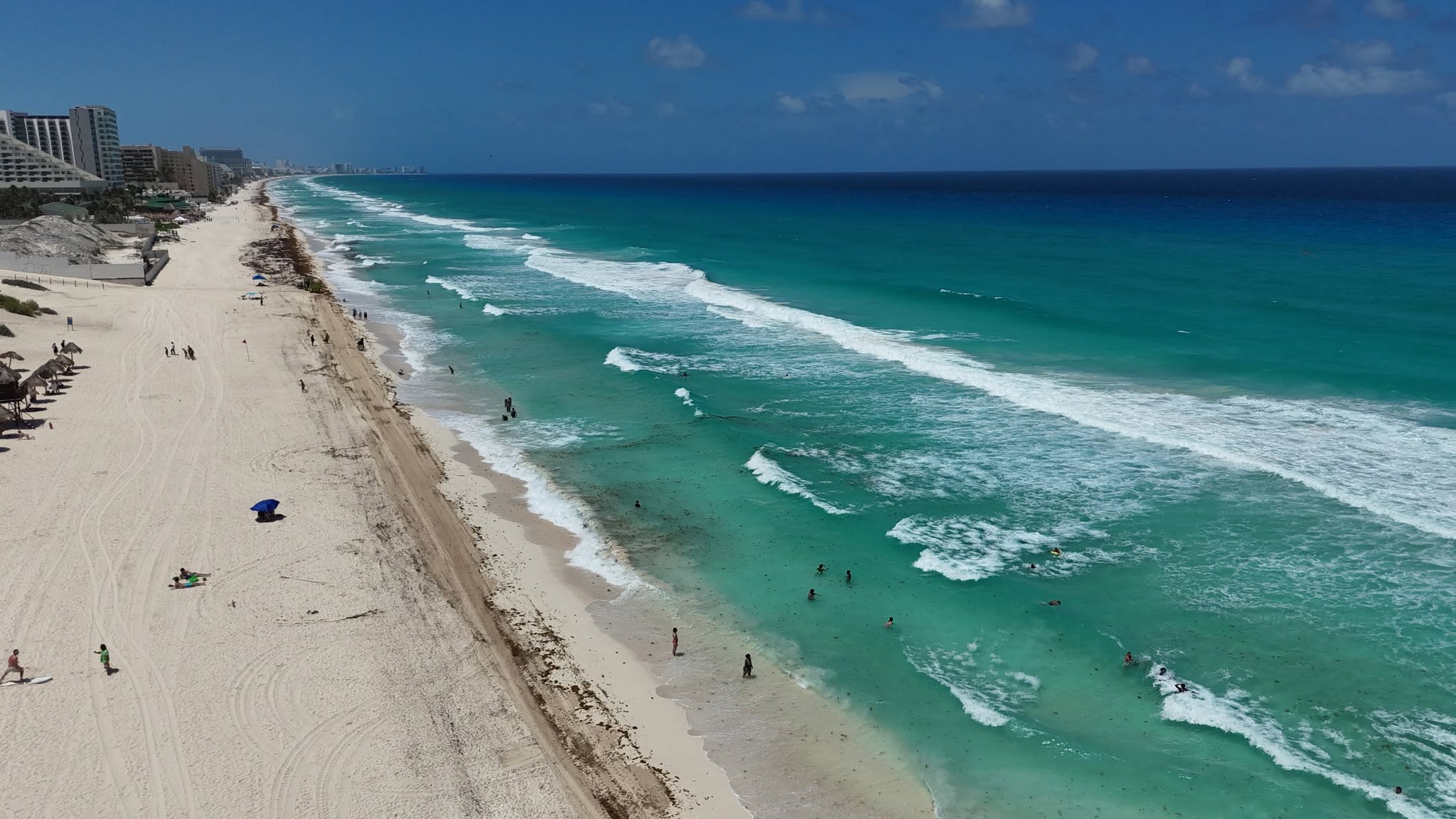 Aerial of Playa Delfines, Cancún, with wide white sand and clear turquoise water