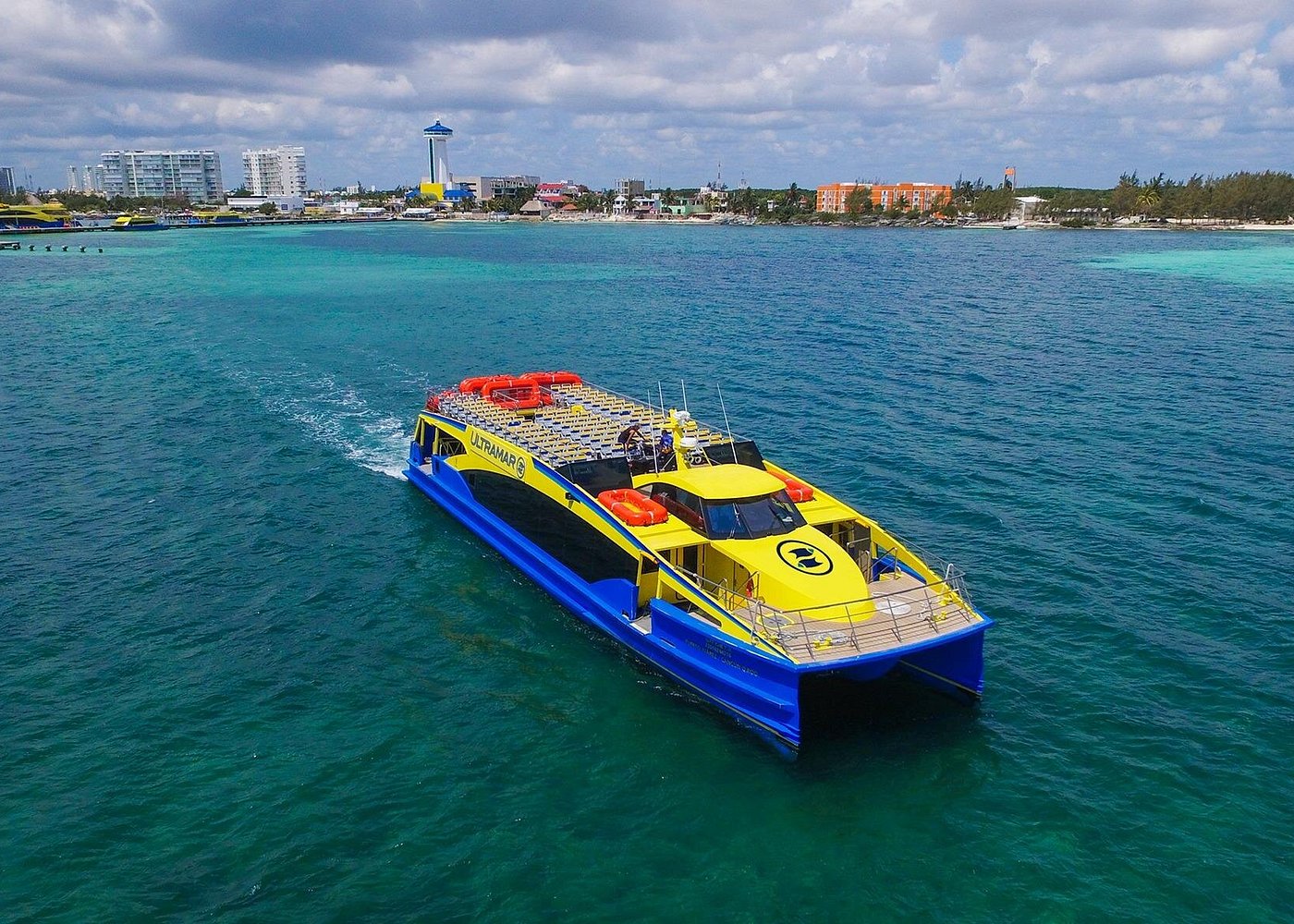 An Ultramar passenger ferry crossing turquoise water