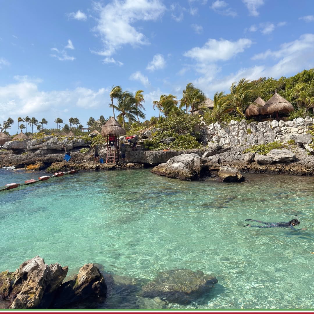 Snorkellers in a clear turquoise cove at a nature park